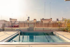 a swimming pool on the roof of a building at The Valentia Cabillers in Valencia