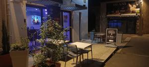 a table and chairs outside of a restaurant at night at Gîte de La Bicyclette in Montournais