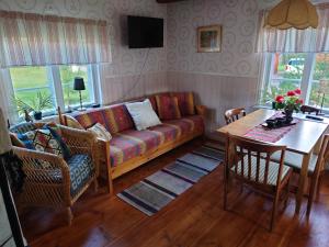 a living room with a couch and a table at Soldattorpet Sands in Leksand