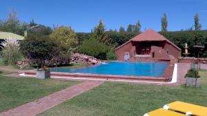 a swimming pool in a yard with a house at La Pilar Petit Chalets in San Rafael