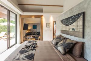 a bedroom with a large bed with a bow on it at Khwan Beach Resort - Luxury Glamping and Pool Villas Samui - Adults Only - SHA Extra Plus in Mae Nam