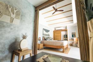 a bedroom with a bed and a mirror at Khwan Beach Resort - Luxury Glamping and Pool Villas Samui - Adults Only - SHA Extra Plus in Mae Nam
