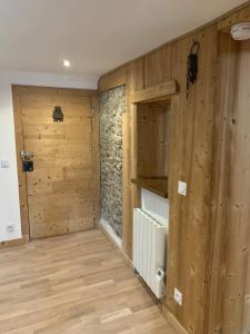 a room with wooden walls and a room with a door at Annecy Sainte Claire proche Gare-Lac Duplex 4e étage pour 4ou6 personnes climatisation in Annecy