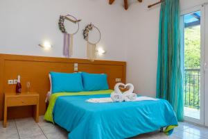 a bedroom with a bed with two towels on it at VILLA MITZELOS in Skiathos