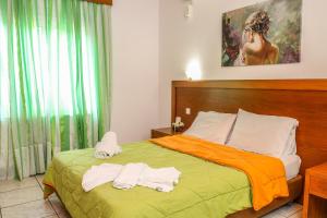 a bedroom with a bed with towels on it at VILLA MITZELOS in Skiathos