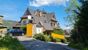 a house with a car parked in front of it at Delta House in Zakopane