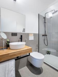 ein Badezimmer mit einem Waschbecken, einem WC und einer Badewanne in der Unterkunft limehome Augsburg Annastraße in Augsburg