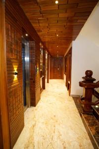a hallway with wooden ceilings and a long hallway with wooden floors at Krishna's Wood Villas in Kolhapur