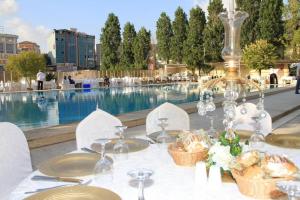a table with a white table cloth and a pool at Florya Park Hotel in Istanbul