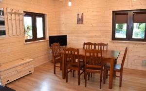 a dining room with a wooden table and chairs at Dom Wycieczkowy "Na stadionie" in Kłodzko