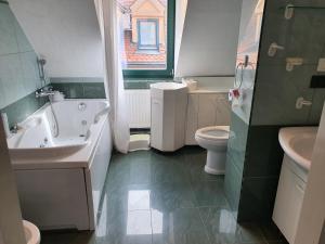 a bathroom with a sink and a tub and a toilet at Dolac Guesthouse in Zagreb +15 photos