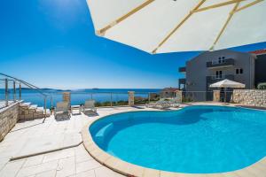 una piscina en un patio con vistas al océano en Apartments Marnic- Blue Chill en Mlini