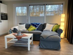 a living room with a couch and a table at Schwimmende Ferienwohnung, Hausboot Urlaub als Festlieger am Steg in Zehdenick