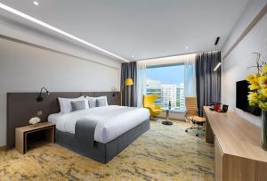 a bedroom with a large bed and a large window at Park Hotel Hong Kong in Hong Kong