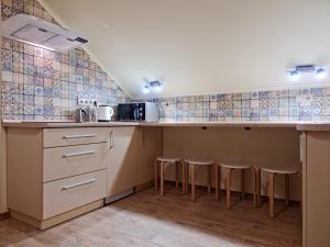 a kitchen with a counter with stools in it at Zelena Saduba in Nevitskoye +32 photos