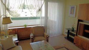 a living room with a chair and a window at Comfortable apartment for 2 Persons in Hannover