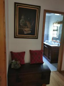 a bathroom with a couch and a sink and a mirror at Alojamento Local Madre de Cima in Vinhais +69 photos