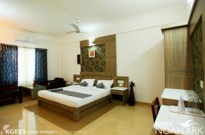 a bedroom with a bed and a living room at Kgees Noah Ark in Thodupuzha
