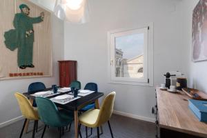 
a room with a table, chairs, and a window at Ca Sveva Venice Apartment M0270429660 in Venice
