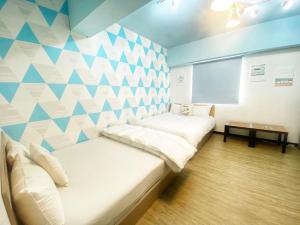 מיטה או מיטות בחדר ב-一中街藻宿 2