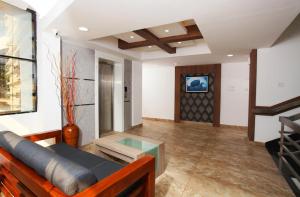 a living room with a couch and a table at Kgees Noah Ark in Thodupuzha