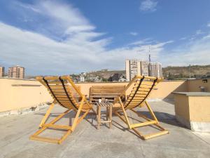 two chairs and a table on top of a roof at hotelise I Tulip Apartment in Yerevan
