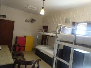 a room with two bunk beds and a table at Hotel Persona International in New Delhi