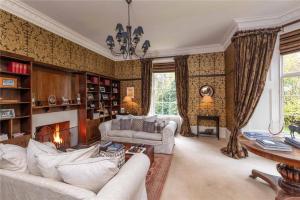 a living room with a couch and a fireplace at Park of Drumquhassle in Glasgow
