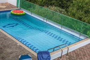 a large swimming pool with a frisbee in it at VILLA MITZELOS in Skiathos