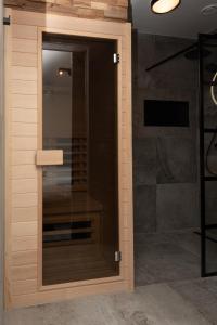 a glass door in a bathroom with a shower at Bomont appartementen 2 persoons - Jan van Renesseweg 1 Renesse in Renesse