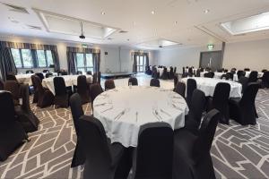 a conference room with tables and chairs in it at Village Hotel Coventry in Coventry