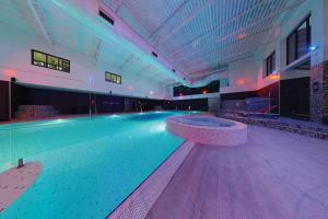 a swimming pool in a building with a bowling alley at Village Hotel Coventry in Coventry