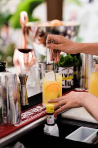 a person making a drink at a bar at Room Mate Anna, Barcelona in Barcelona