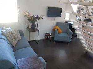 a living room filled with furniture and a tv at Erve Het Roolvink Appartementen in Enschede