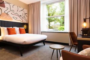 a hotel room with a bed and a window at Huygens Place Amsterdam in Amsterdam