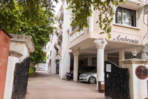 a white building with a car parked in front of it at Greams Road Near - Apollo - Fusion Serviced Apartments in Chennai