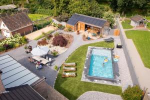 an aerial view of a backyard with a swimming pool at Bed & Breakfast 't Vèèrke in Dilsen-Stokkem