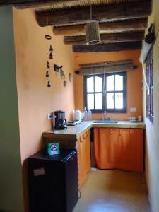 a kitchen with a sink and a counter top at Los Amarantos in Tilcara