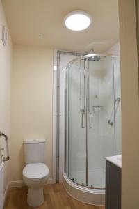 a bathroom with a toilet and a glass shower at Hazeldean in Manchester