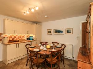 a kitchen with a table and chairs in a room at Greywalls in Penrith