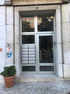 una puerta a un edificio con una maceta delante en Guest House Guerra Junqueiro en Lisboa