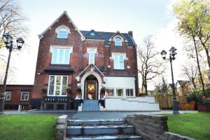 a large brick building with a front door at Hazeldean in Manchester