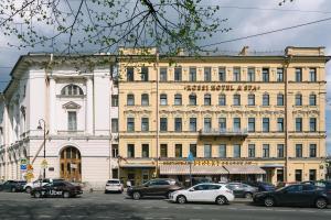 a large building with cars parked in front of it at Rossi Boutique Hotel in Saint Petersburg