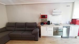 a living room with a couch and a kitchen at Alcazaba - Free Parking in Mérida