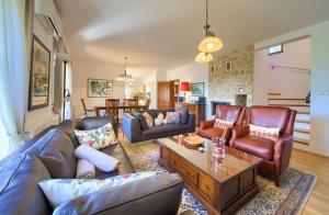 a living room with couches and a table at Villa Maria in Sužan