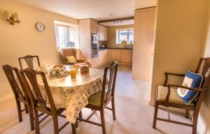 a kitchen and dining room with a table and chairs at Valley View Farm Holiday Cottages in Helmsley