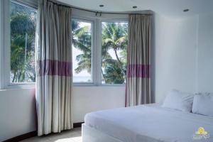 Postel nebo postele na pokoji v ubytování Rosy Sea Front Beach Condo + 22 fotografií