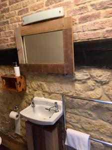a bathroom with a sink and a mirror at The George Hotel in Castle Cary