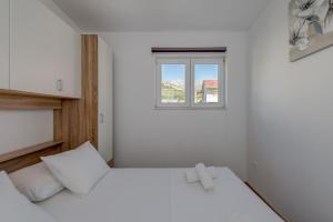 Postel nebo postele na pokoji v ubytování Apartmani Zaja