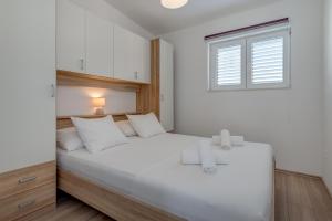 Postel nebo postele na pokoji v ubytování Apartmani Zaja